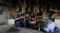 FILE PHOTO: A laundryman uses cell phone as he sits at his shop during country-wide power breakdown in Peshawar, Pakistan January 23, 2023. REUTERS/Fayaz Aziz/File Photo