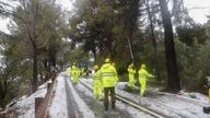 Workers remove fallen branches and trees after a heavy snow in Serra de Tramuntana mountains in Mallorca, Spain, February 28, 2023. Storm Juliette sets off a cold weather alert in 30 provinces of Spain, leaving temperatures close to zero degrees in the Spanish Balearic island of Mallorca. REUTERS/Enrique Calvo
