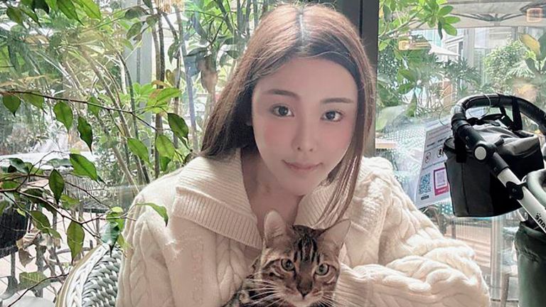 In this photo taken and provided by Pao Jo-yee, model Abby Choi, holding a cat, poses for a photo on Feb. 11, 2023, in Hong Kong. The ex-husband and former in-laws of the slain Hong Kong model were put in custody without bail Monday, Feb. 27, 2023, on a joint murder charge, after police found parts of her body in a refrigerator.(Pao Jo-yee via AP)