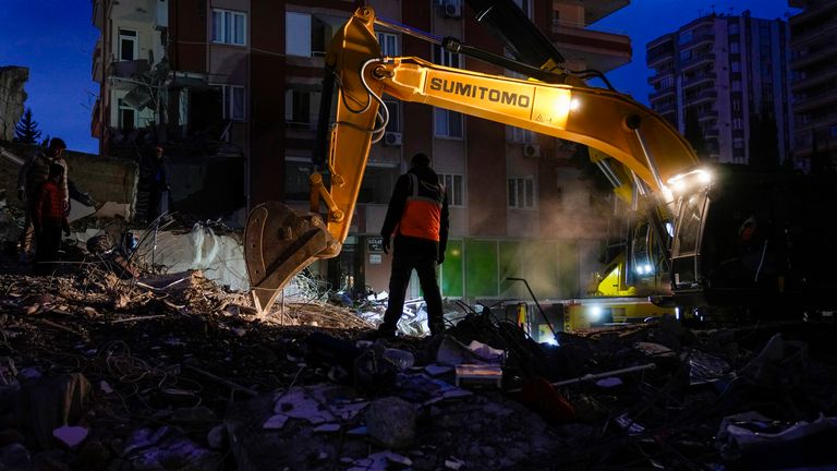 Emergency team members search for people in a destroyed building in Adana 
Pic:AP