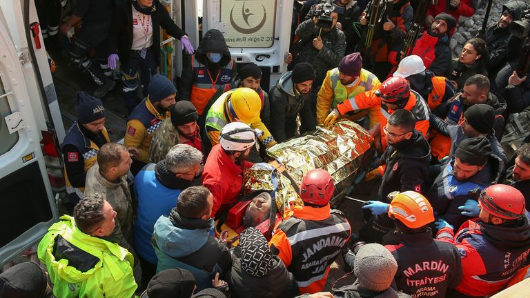 Rescue workers carry Eyup Ak, 60, to an ambulance after pulling him out alive from a collapsed building, 104 hours after the earthquake, in Adiyaman 
Pic:AP