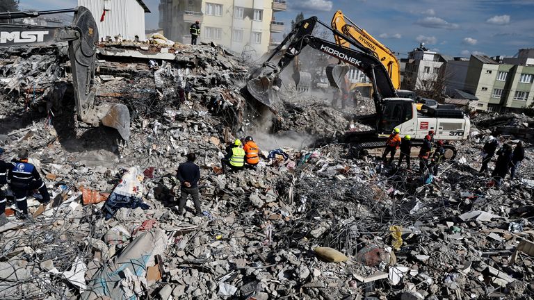 Search and rescue teams work on a collapsed building in Adiyaman, Turkey