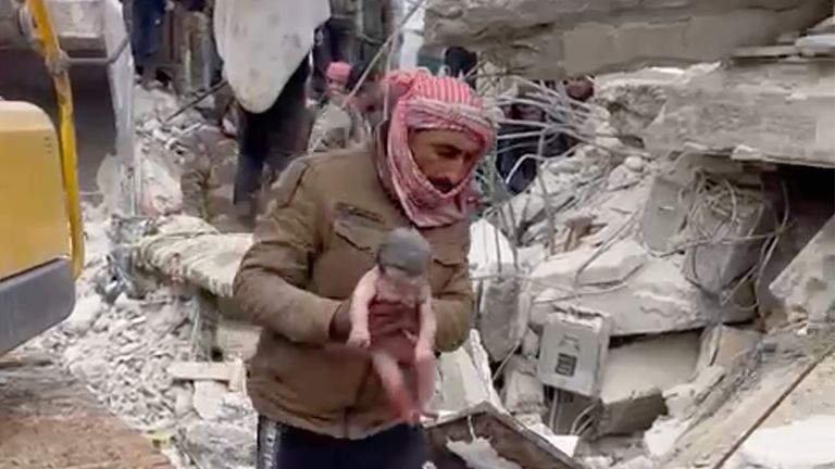 A rescuer carries a baby girl after pulling her from the rubble caused by an earthquake that hit Syria and Turkey in the town of Jinderis, Syria, Tuesday, Feb. 7, 2023. Pic: AP