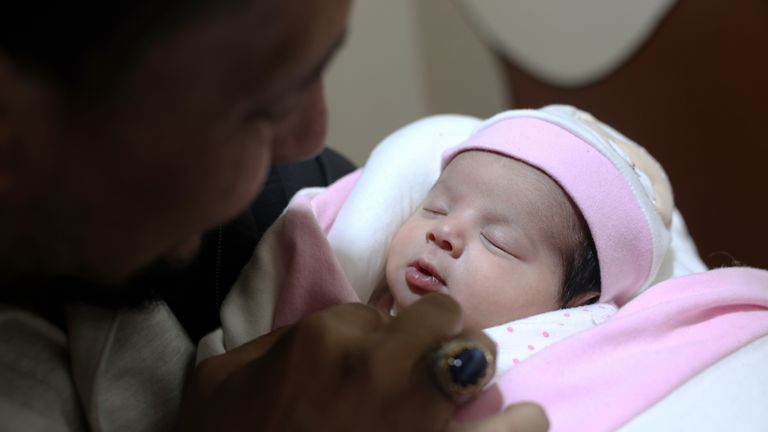 'Miracle baby' born in quake rubble is adopted by her aunt and uncle - and given a new name