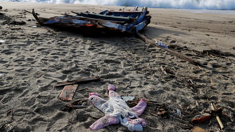 A piece of the boat and a piece of clothing from the deadly migrant shipwreck are seen in Steccato di Cutro near CrotoneItaly, February 28, 2023. REUTERS/Remo Casilli
