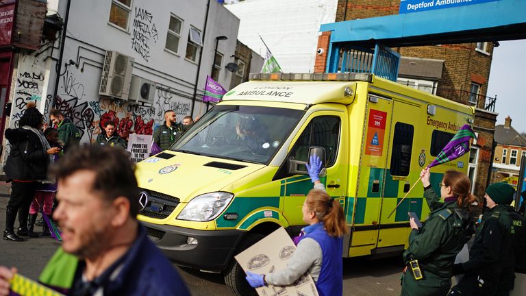 An ambulance leaves London Ambulance Service (LAS) in Deptford, south-east London, as ambulance workers stand on the picket line, during a strike by members of the Unison union in the long-running dispute over pay and staffing. Picture date: Friday February 10, 2023.
