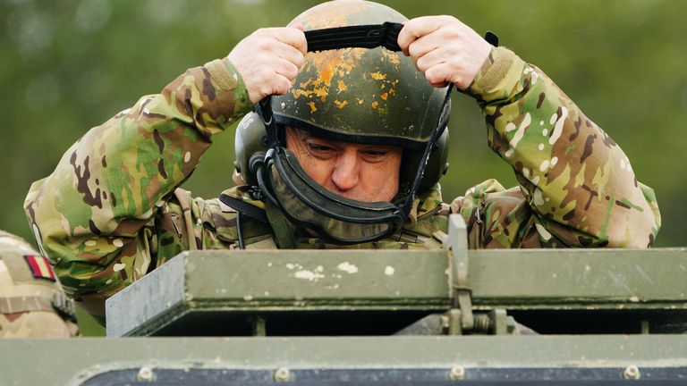 Defence Secretary Ben Wallace adjusts his eyewear as he is given a demonstration of an Ajax armoured personnel carrier during a visit to Bovington Camp, a British Army military base in Dorset, to view Ukrainian soldiers training on Challenger 2 tanks. Picture date: Wednesday February 22, 2023.