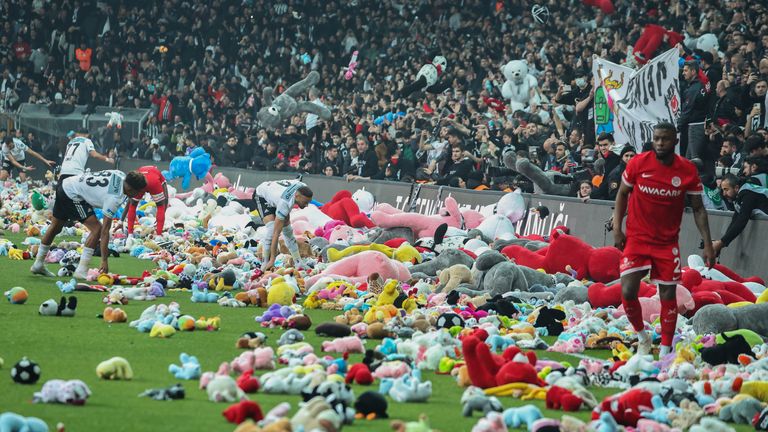 Fans throw toys onto the pitch during the Turkish Super League soccer match between Besiktas and Antalyaspor at the Vodafone stadium in Istanbul, Turkey, Sunday, Feb. 26, 2023. During the match, supporters threw a massive number of soft toys to be donated to children affected by the powerful earthquake on Feb. 6 on southeast Turkey. (AP Photo)