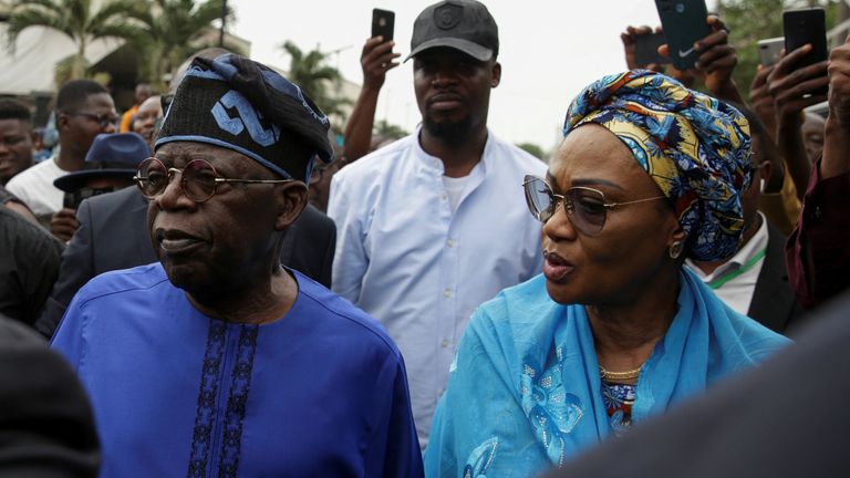 Presidential candidate Bola Ahmed Tinubu arrives with his wife Oluremi Tinubu at a polling station before casting his ballot in Ikeja, Lagos