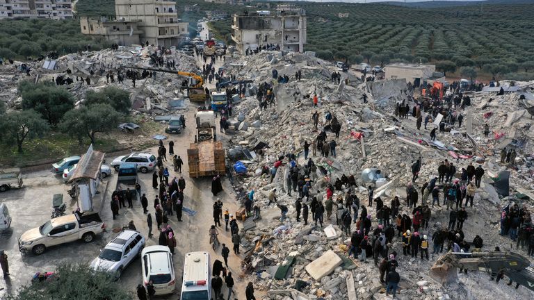 Civil defense workers and residents search through the rubble of collapsed buildings in the town of Harem near the Turkish border, Idlib province, Syria 
Pic:AP