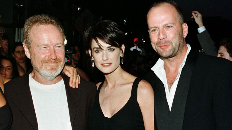 Willis with his then-wife, Demi Moore, at the premiere of GI Jane, which was directed by Ridley Scott, left