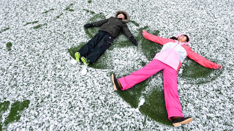 Children make snow angels after about 1,400 feet of snowfall in Rancho Cucamonga, California