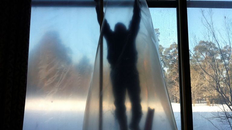 FILE PHOTO: A man repairs the window of a sports hall damaged by a shockwave from a meteor in the Urals city of Chelyabinsk February 16, 2013. REUTERS/Olaf Koens/File Photo