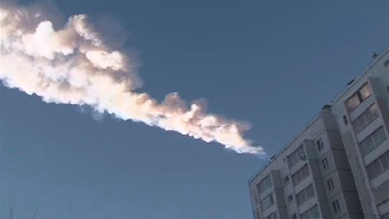 The trail of a falling object is seen above a residential apartment block in the Urals city of Chelyabinsk, in this still image taken from video shot on February 15, 2013. A powerful blast rocked the Russian region of the Urals early on Friday with bright objects, identified as possible meteorites, falling from the sky, emergency officials said. REUTERS/OOO Spetszakaz (RUSSIA - Tags: ENVIRONMENT TPX IMAGES OF THE DAY)