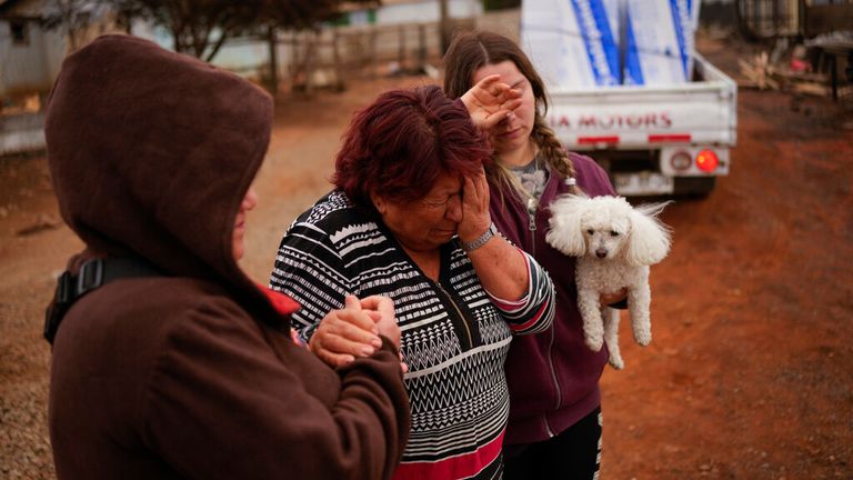 La résidente Rosa Munoz (au centre) a perdu sa maison après que des incendies de forêt ont ravagé la ville de Tome, dans la région de Biobio Pic: AP 