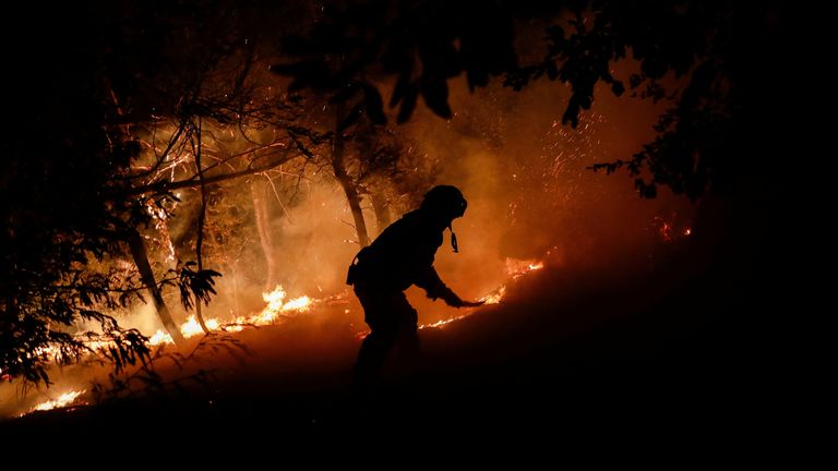 A firefighter works, as a wildfire burns parts of rural areas in Quillon, Chile, February 2, 2023 REUTERS/Juan Gonzalez