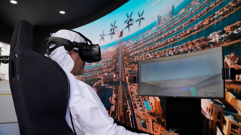A man experiences a driving simulator of a flying taxi. Pic: AP