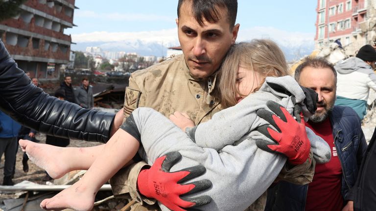 Muhammet Ruzgar, 5, is carried out by a rescuer from the site of a damaged building, following an earthquake in Hatay, Turkey, February 7, 2023. REUTERS/Umit Bektas