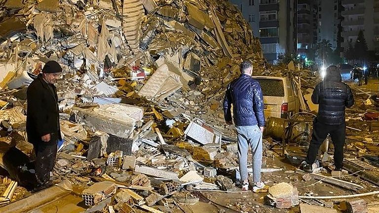 People try to reach trapped residents inside collapsed buildings in Diyarbakir, southern Turkey, early Monday, Feb. 6, 2023. A powerful earthquake has caused significant damage in southeast Turkey and Syria and many casualties are feared. Damage was reported across several Turkish provinces, and rescue teams were being sent from around the country. (Depo Photos via AP)