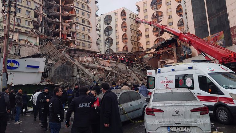 Rescue workers and medical teams try to reach trapped residents in a collapsed building following an earthquake in Diyarbakir, southeastern Turkey, early Monday, Feb. 6, 2023. A powerful earthquake has caused significant damage in southeast Turkey and Syria and many casualties are feared. Damage was reported across several Turkish provinces, and rescue teams were being sent from around the country. (AP Photo/Mahmut Bozarsan)