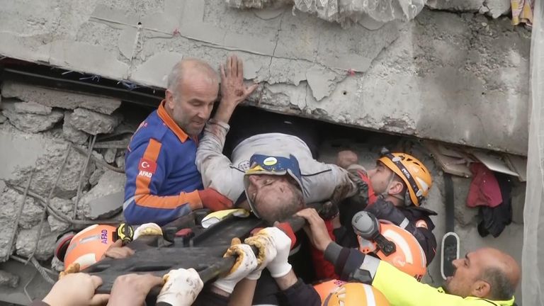 People are assisting in the rescue of other locals in the Turkish town of Pazarcik on Monday after a magnitude 7.8 earthquake shook large swaths of Turkey and neighboring Syria. .