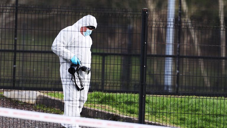 A forensic investigator from Police Service of Northern Ireland (PSNI) inspects the ground at the sports complex in the Killyclogher Road area of Omagh, Co Tyrone, where off-duty PSNI Detective Chief Inspector John Caldwell was shot a number of times by masked men in front of young people he had been coaching. Mr Caldwell remains in a critical but stable condition in hospital following the attack on Wednesday evening. Picture date: Thursday February 23, 2023.