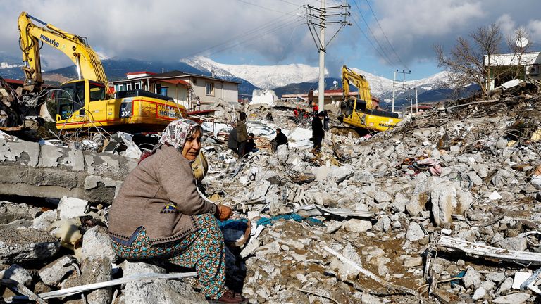 A woman sits amidst rubble and damages following an earthquake in Gaziantep, Turkey, February 7, 2023. REUTERS/Suhaib Salem