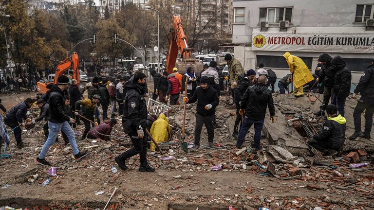 People and emergency teams search for people in the rubble of a destroyed building in Gaziantep, Turkey. Pic: AP