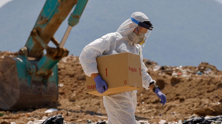 A police carries a box of evidence during a search for the missing parts of 28-year-old model Abby Choi&#39;s body in Hong Kong, 