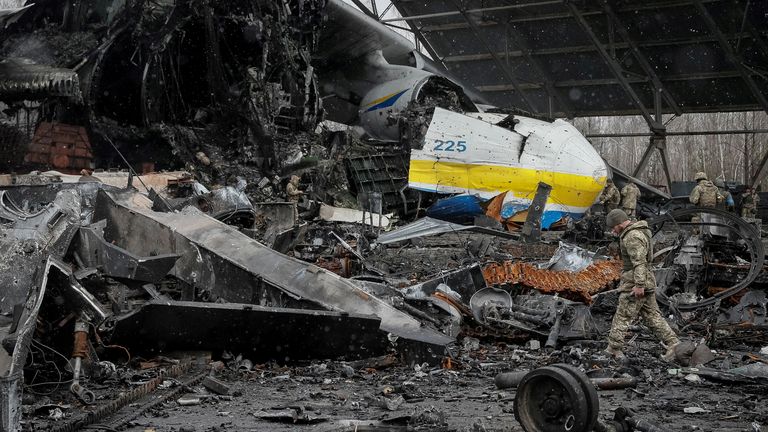 FILE PHOTO: A Ukrainian service member walks in a front of an Antonov An-225 Mriya cargo plane, the world&#39;s biggest aircraft, destroyed by Russian troops as Russia&#39;s attack on Ukraine continues, at an airfield in the settlement of Hostomel, in Kyiv region, Ukraine, April 3, 2022. REUTERS/Gleb Garanich SEARCH " UKRAINE-CRISIS/ANNIVERSARY-TIMELINE" FOR ALL IMAGES/File Photo
