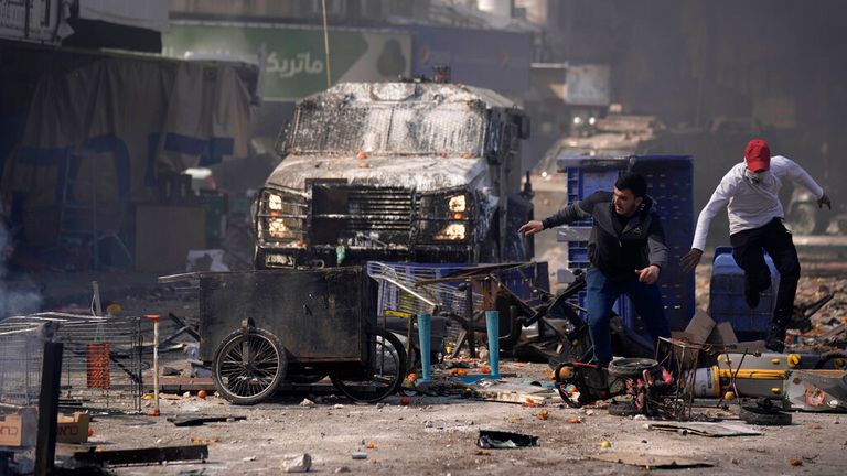 Palestinians clash with Israeli forces in the West Bank city of Nablus, Wednesday, Feb. 22, 2023. Israeli troops moved into the city, setting off fighting that killed several Palestinians, including a 72-year-old man, Palestinian health officials said. The Israeli military gave few details about its operation in the northern city, which is known as a militant stronghold, and the army frequently operates there. (AP Photo/Majdi Mohammed)