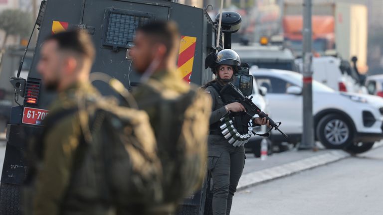 Israeli security forces stand at the site of a shooting attack in Huwara area. Pic: AP