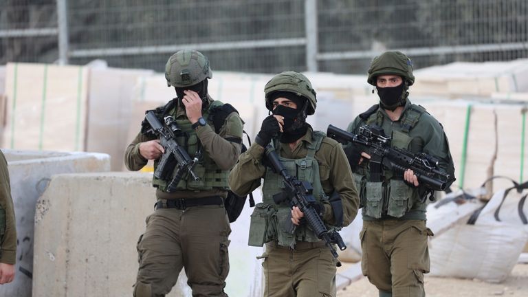 Israeli security forces stand at the site of a shooting attack in Huwara area. Pic: AP