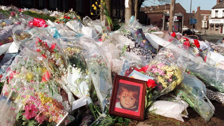 A photograph of murdered two-year-old James Bulger sits alongside hundreds of flowers at the spot where his body was found in Walton, Liverpool.  February 19, 1993
