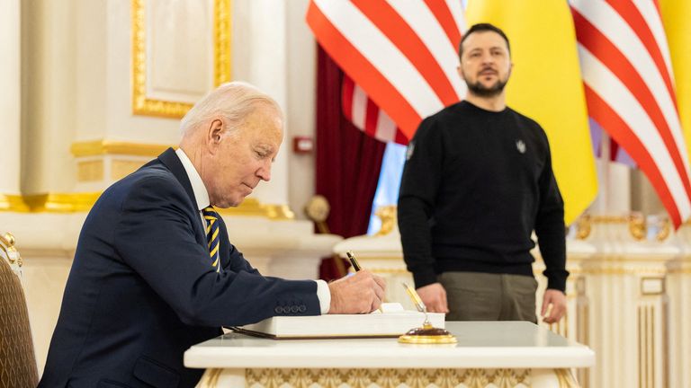 U.S. President Joe Biden leaves a sign in a book as Ukraine&#39;s President Volodymyr Zelenskiy stands next, amid Russia&#39;s attack on Ukraine, in Kyiv, Ukraine February 20, 2023. Ukrainian Presidential Press Service/Handout via REUTERS ATTENTION EDITORS - THIS IMAGE HAS BEEN SUPPLIED BY A THIRD PARTY.