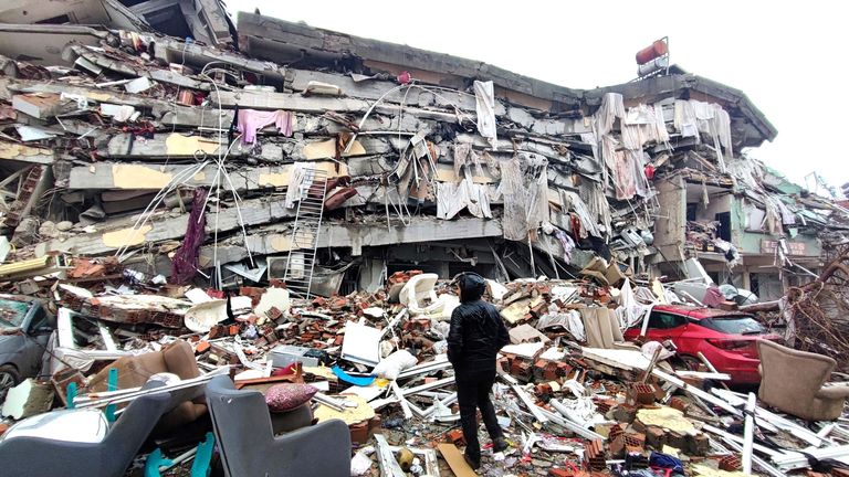 A man stands in front of collapsed buildings after the earthquake in Kahramanmaras, TurkeyCredit: IHA/reuters