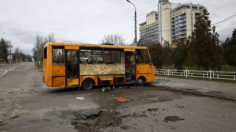 A damaged bus parks next to an impact by shelling on the first anniversary of the Russian invasion of Ukraine, in Kherson, Ukraine February 24, 2023. REUTERS/Lisi Niesner
