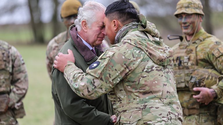King Charles III receives the hongi - the traditional Maori greeting - from a New Zealander who is part of the Ukrainian contingent, during a visit to a training site for Ukrainian military recruits, in Wiltshire, where recruits are completing five weeks of basic combat training by British and international partner forces, before returning to fight in Ukraine. Picture date: Monday February 20, 2023.
