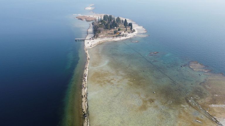 A drone image shows San Biagio island, affected by drought in Lake Garda, near Lido di Manerba, Italy, 21 February, 2023. REUTERS/Alex Fraser
