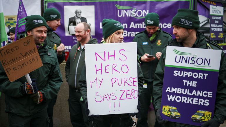 People protest in front of the London Ambulance Service during a strike by ambulance workers due to a dispute with the government over pay, in London,