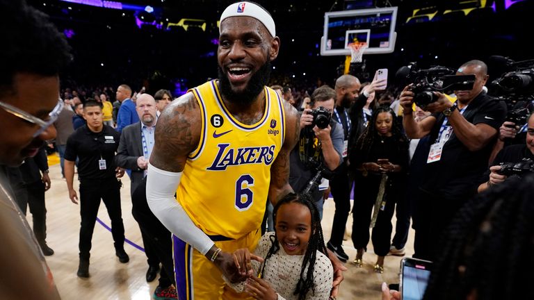Los Angeles Lakers forward LeBron James celebrates with his daughter Juri after passing Kareem Abdul-Jabbar as the NBA's all-time leading scorer Pic:AP