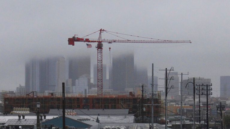 Storm clouds hang over high-rise buildings in downtown Los Angeles