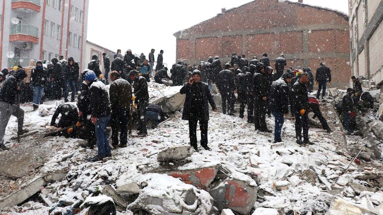 Rescuers carry out a person from a collapsed building after an earthquake in Malatya, Turkey  
Pic:Ihlas/Reuters