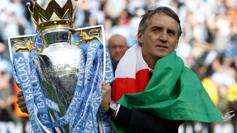 Manchester City manager Roberto Mancini celebrates with the trophy during the Barclays Premier League match at the Etihad Stadium, Manchester, in 2012.