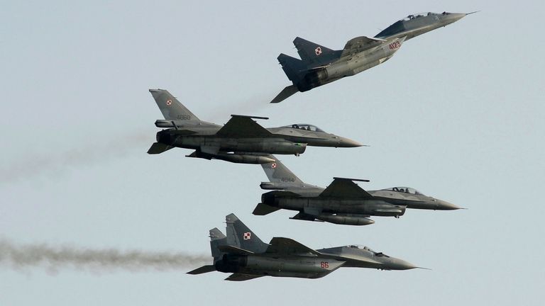 Two Polish Air Force Russian made Mig 29&#39;s fly above and below two Polish Air Force U.S. made F-16&#39;s fighter jets during the Air Show in Radom, Poland, Saturday, Aug. 27, 2011. (AP Photo/Alik Keplicz)