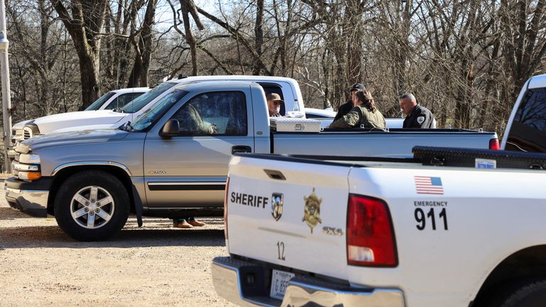 Law enforcement members gather next to the vehicle of the victim of a shooting outside a gas station convenience store in Arkabutla, Mississippi, U.S. February 17, 2023. REUTERS/Maria Alejandra Cardona