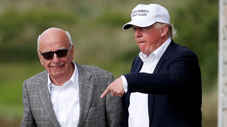 Donald Trump speaks to media mogul Rupert Murdoch as they walk out of Trump International Golf Links in Aberdeen, Scotland, June 25, 2016. REUTERS/Carlo Allegri/File Photo