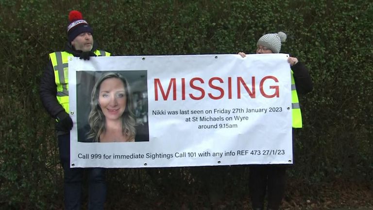 People hold placards appealing for information about missing Nicola Bulley in Lancashire