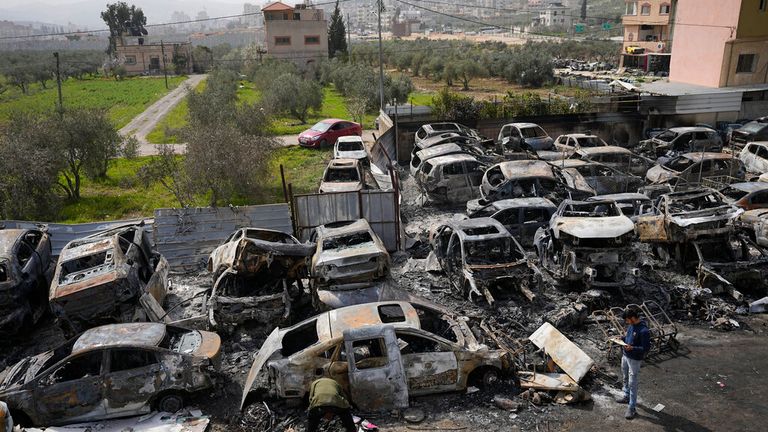 At least 25 cars were set alight in revenge riots in Hawara Pic: AP 