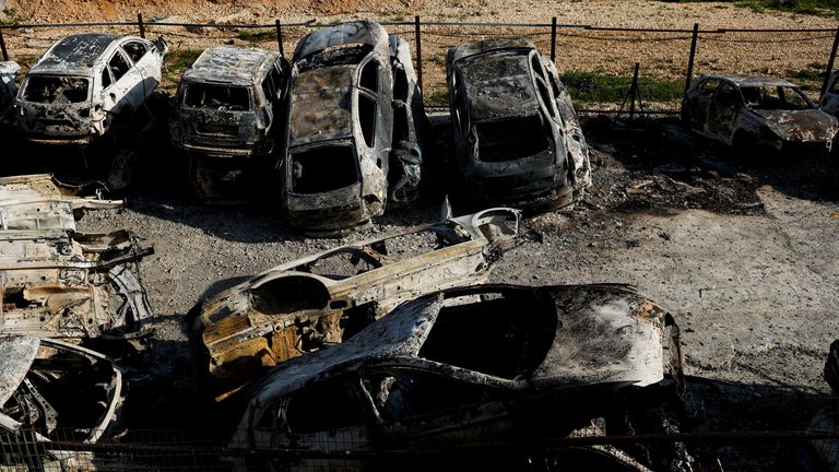 A view of cars burned in an attack by Israeli settlers following an incident where a Palestinian gunman killed two Israeli settlers near Hawara in the Israeli-Occupied West Bank, February 27, 2023. REUTERS/Ammar Awad